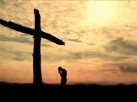 mankneelingatthecross